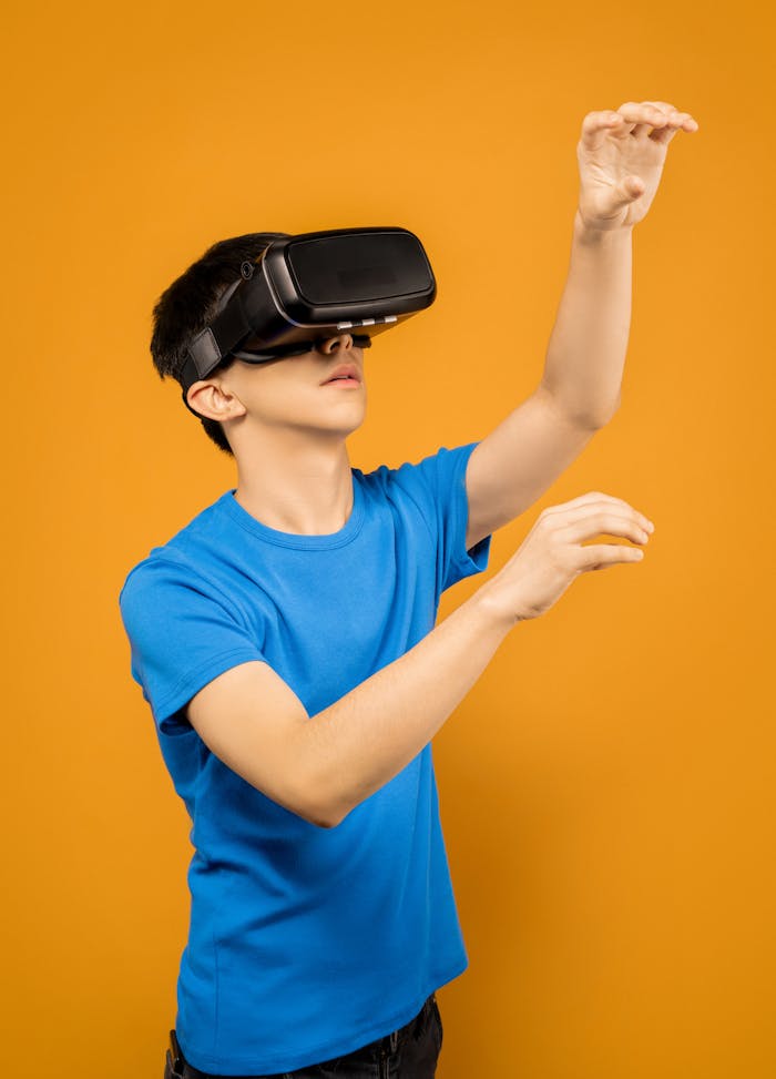 Man in blue shirt experiencing virtual reality with headset against vibrant orange background.